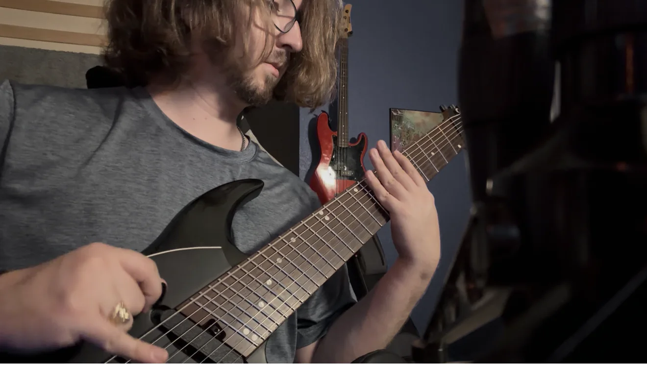 Both hands on an extended-range guitar